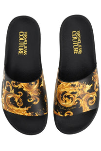 Versace Jeans Couture women’s black slides featuring a bold gold ornate baroque pattern on the footbed