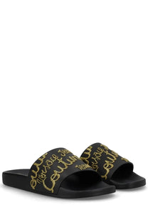 Versace Jeans Couture women’s black slide sandals with bold gold glitter script logo on the strap