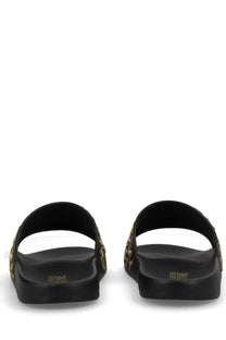 Versace jeans couture women’s black slide sandals with gold-tone embellishments along the sides