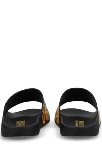 Versace jeans couture women’s black slide sandals with gold-toned flame-patterned side panels and embossed heel branding