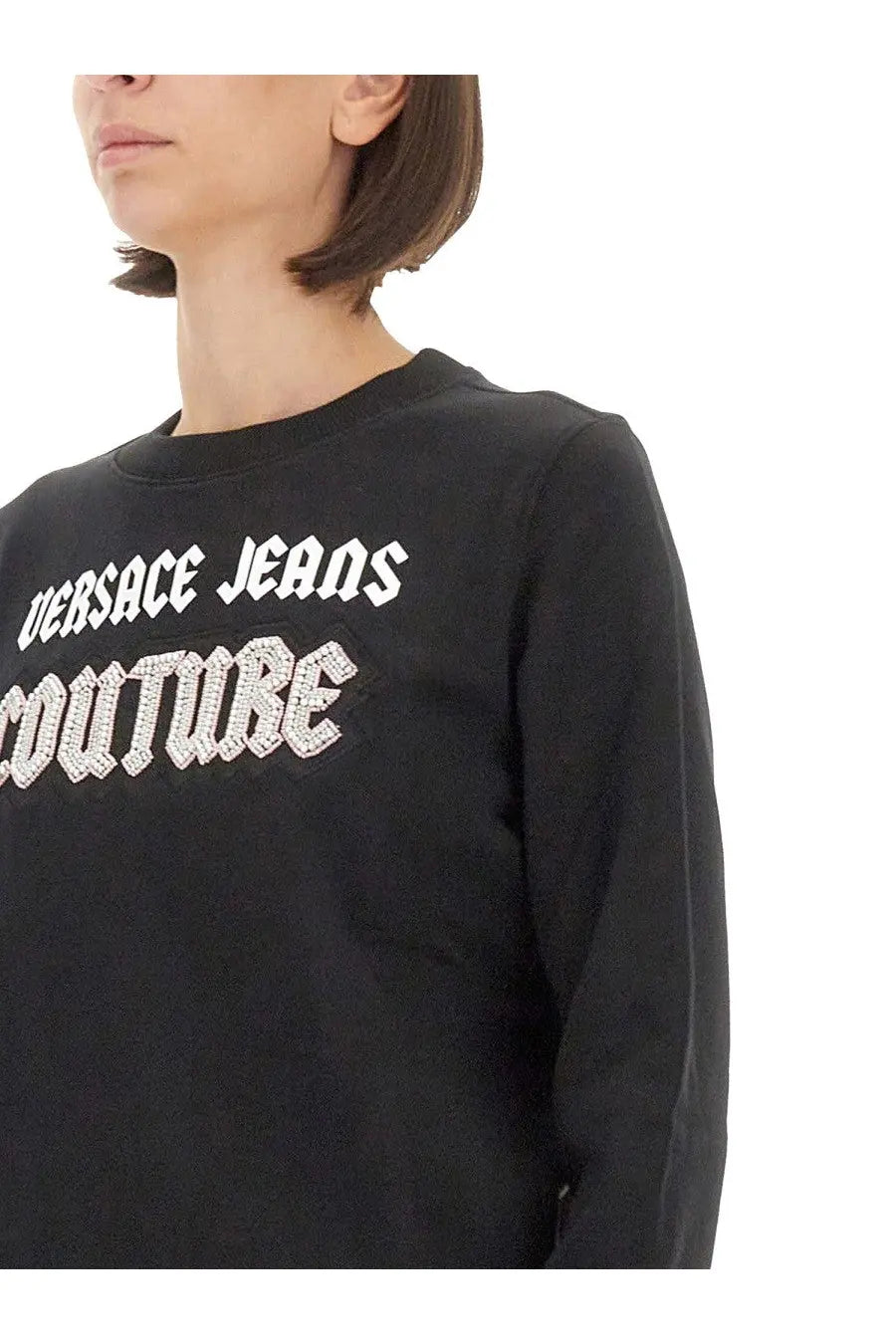 Black versace jeans couture women’s sweatshirt with long sleeves featuring white lettering and rhinestone embellishments