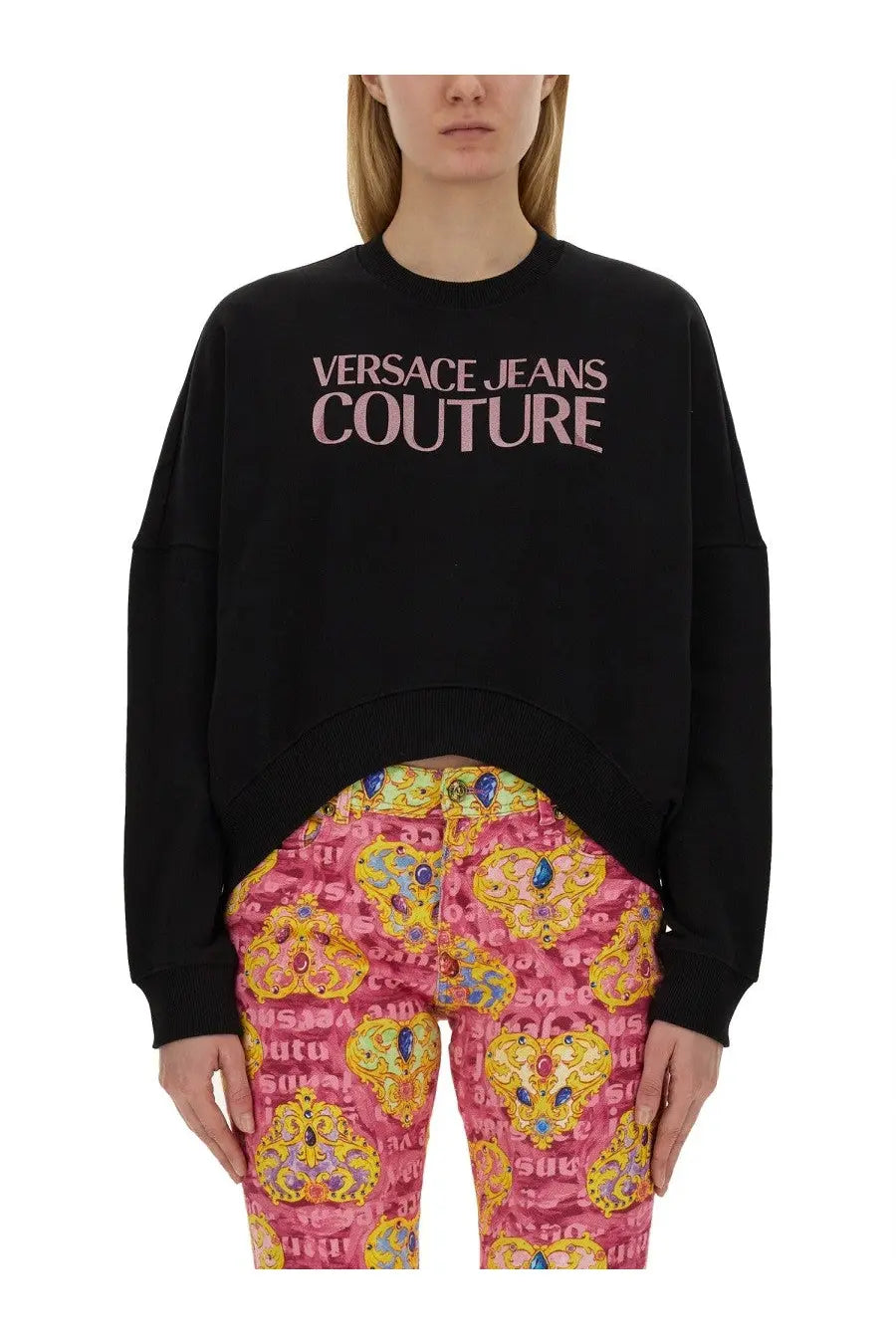 Versace Jeans Couture women’s black oversized sweatshirt with pink logo print across the chest