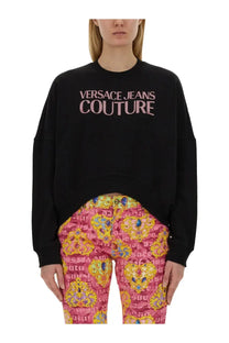 Versace Jeans Couture women’s black oversized sweatshirt with pink logo print across the chest