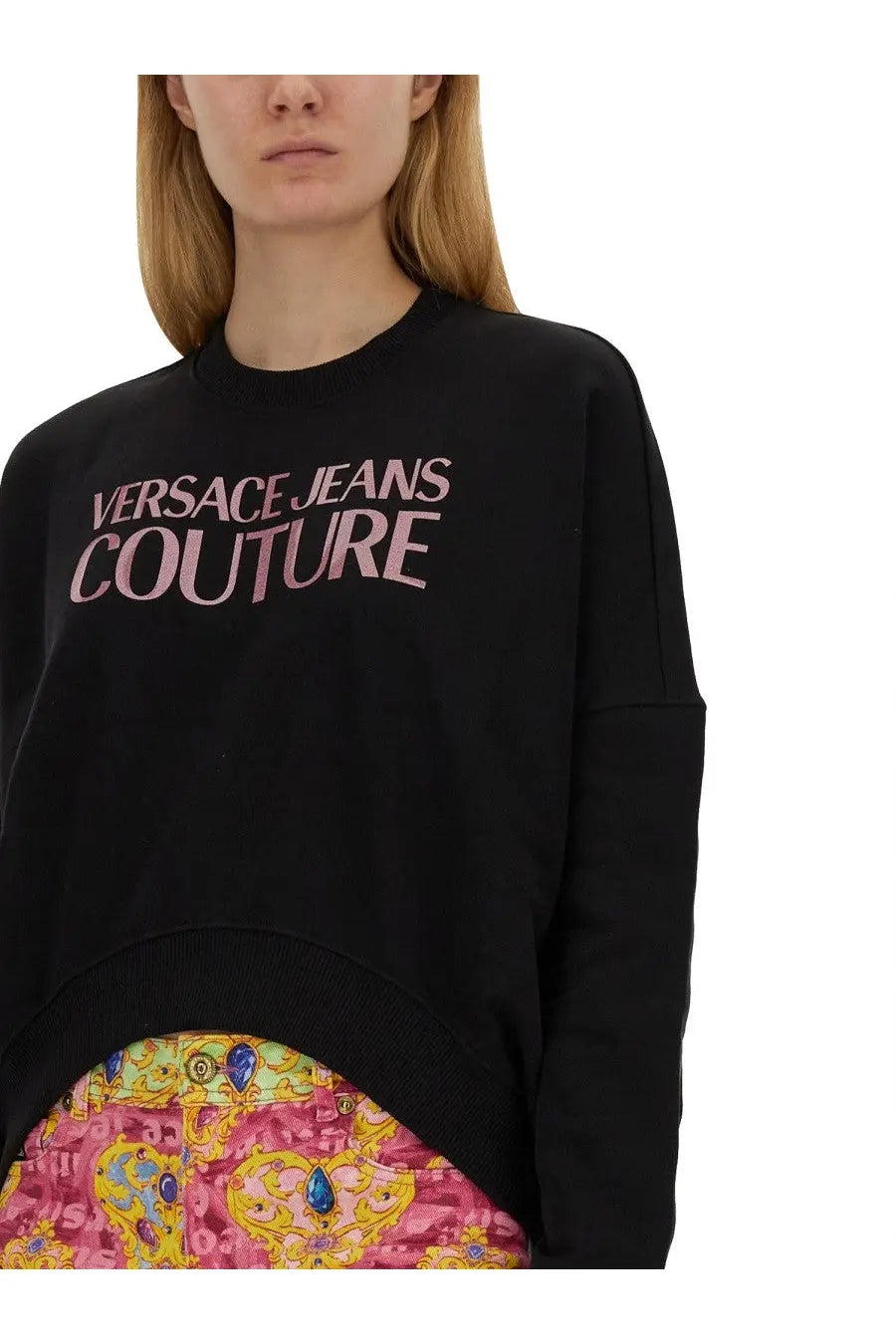 Black oversized versace jeans couture women’s sweatshirt with pink logo print across the chest