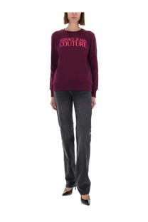 A maroon versace jeans couture womens sweatshirt with bold pink lettering across the chest