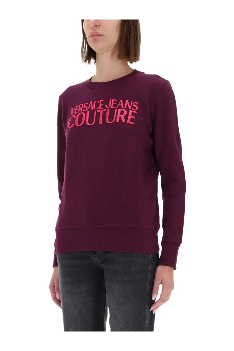 A maroon long-sleeved versace jeans couture sweatshirt with a bold pink logo across the chest for women