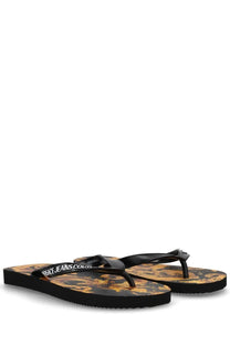 Versace jeans couture women’s black thong sandal with gold ornate patterned sole and white logo lettering