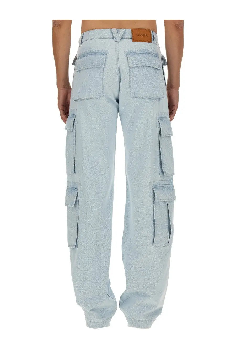 Versace men’s light-wash denim cargo jeans with multiple pockets and brown leather brand patch at the waistband