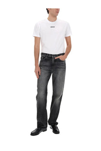 Versace men’s black jeans paired with a white t-shirt featuring a black logo on the chest