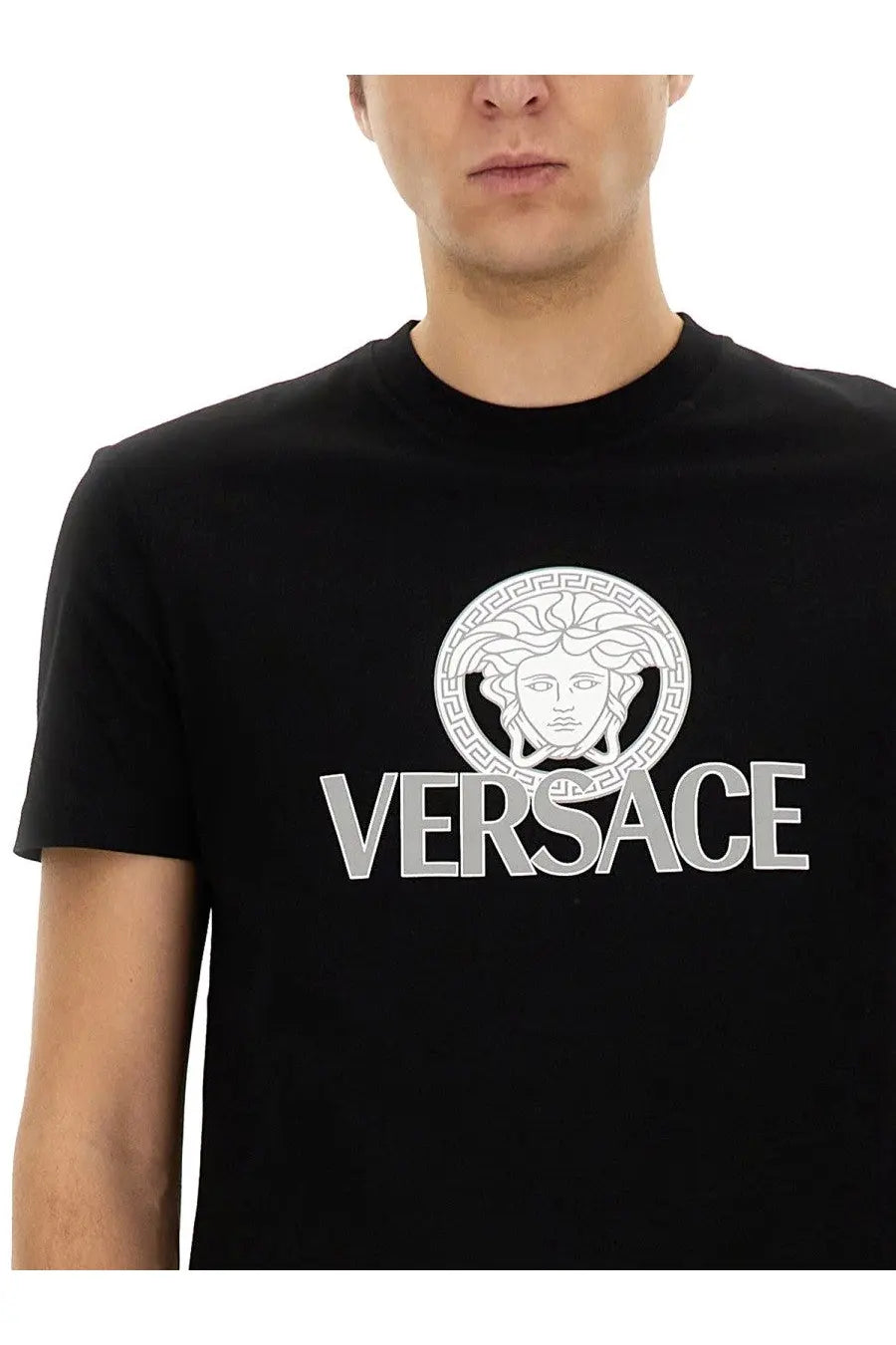 Versace men’s black jersey t-shirt featuring a bold white medusa head logo with greek key patterns and silver versace lettering