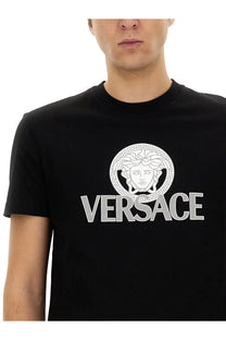Versace men’s black jersey t-shirt featuring a bold white medusa head logo with greek key patterns and silver versace lettering