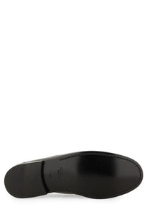 Black leather sole with glossy finish and visible stitching on versace men’s moccasin medusa white shoes