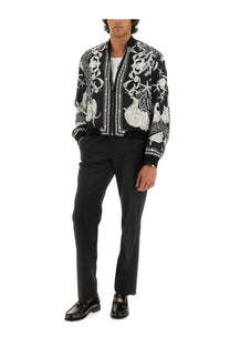 Versace men’s black bomber jacket with intricate white baroque embroidery and piping reversible in multicolor design