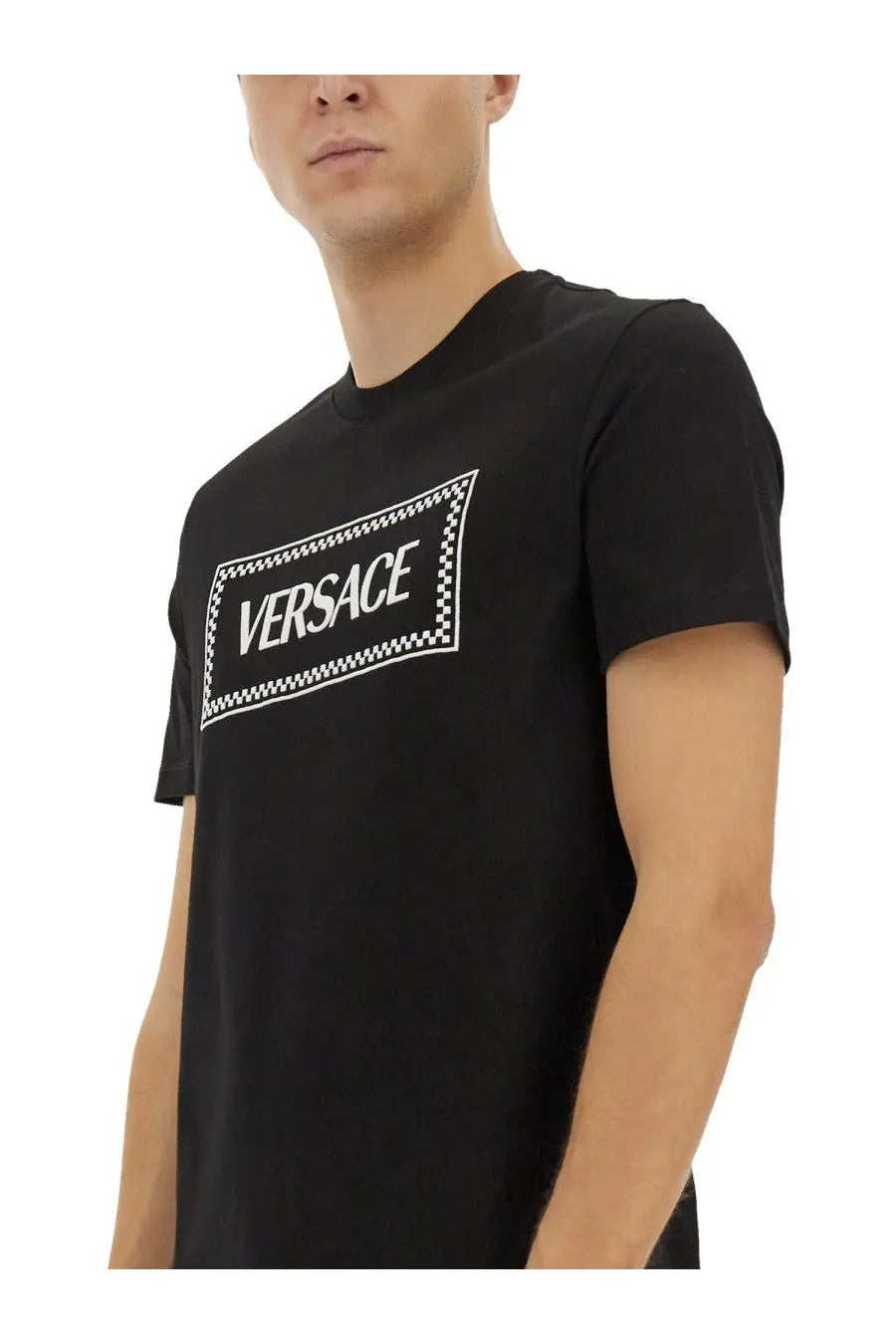 Versace men’s black t-shirt featuring a bold white logo with a checkered border design on the front