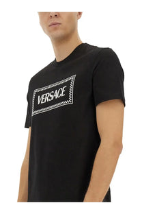 Versace men’s black t-shirt featuring a bold white logo with a checkered border design on the front