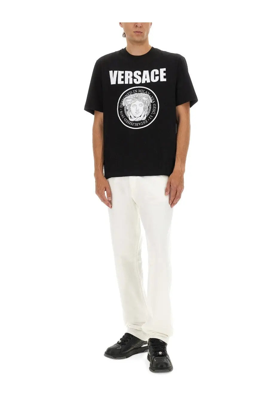 Versace men’s black cotton t-shirt featuring bold white logo with medusa head emblem and established in Milan text