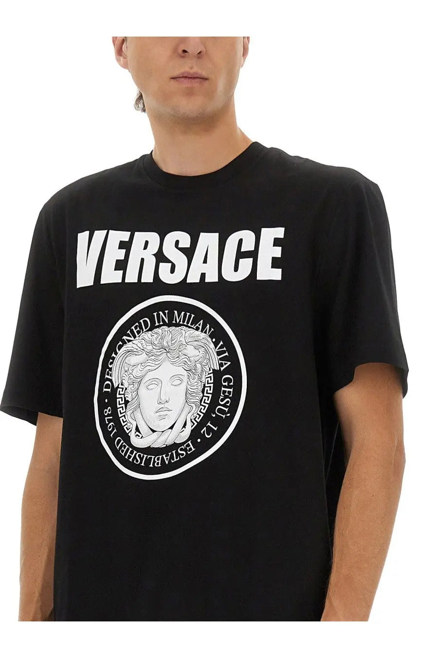 Versace men’s black t-shirt featuring a bold white circular logo with medusa head and Versace branding