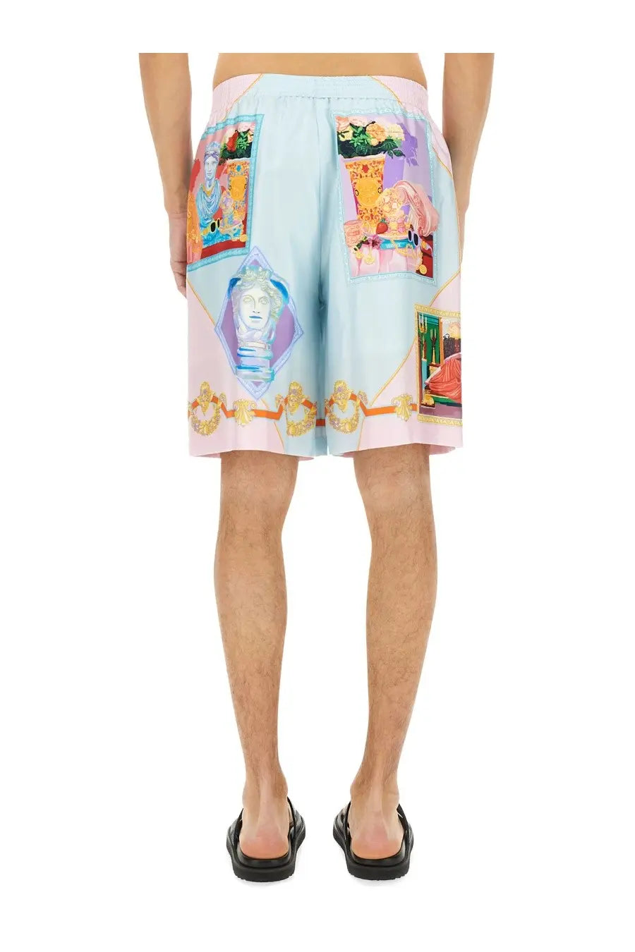 Versace men’s silk shorts in light blue and pink with vibrant classical motifs and gold accents