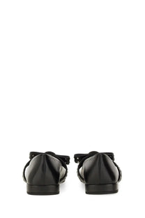 Back view of versace women’s ballerina gianni ribbon black patent leather flats with decorative bow and studded straps