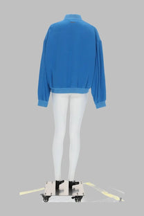 Versace women’s bright blue bomber jacket in popeline di seta with ribbed cuffs and hem displayed on a mannequin
