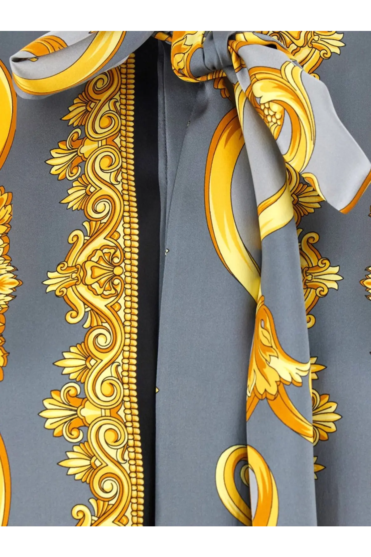 Versace women’s cheetah foulard lavallière silk shirt with gray silk scarf tied in a bold gold baroque bow