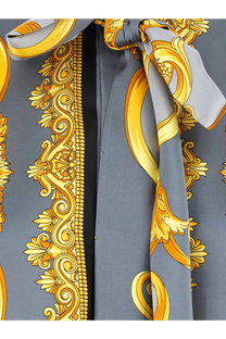 Versace women’s cheetah foulard lavallière silk shirt with gray silk scarf tied in a bold gold baroque bow