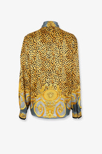 Versace women’s cheetah foulard lavallière silk shirt in gold and black leopard print with ornate baroque detailing