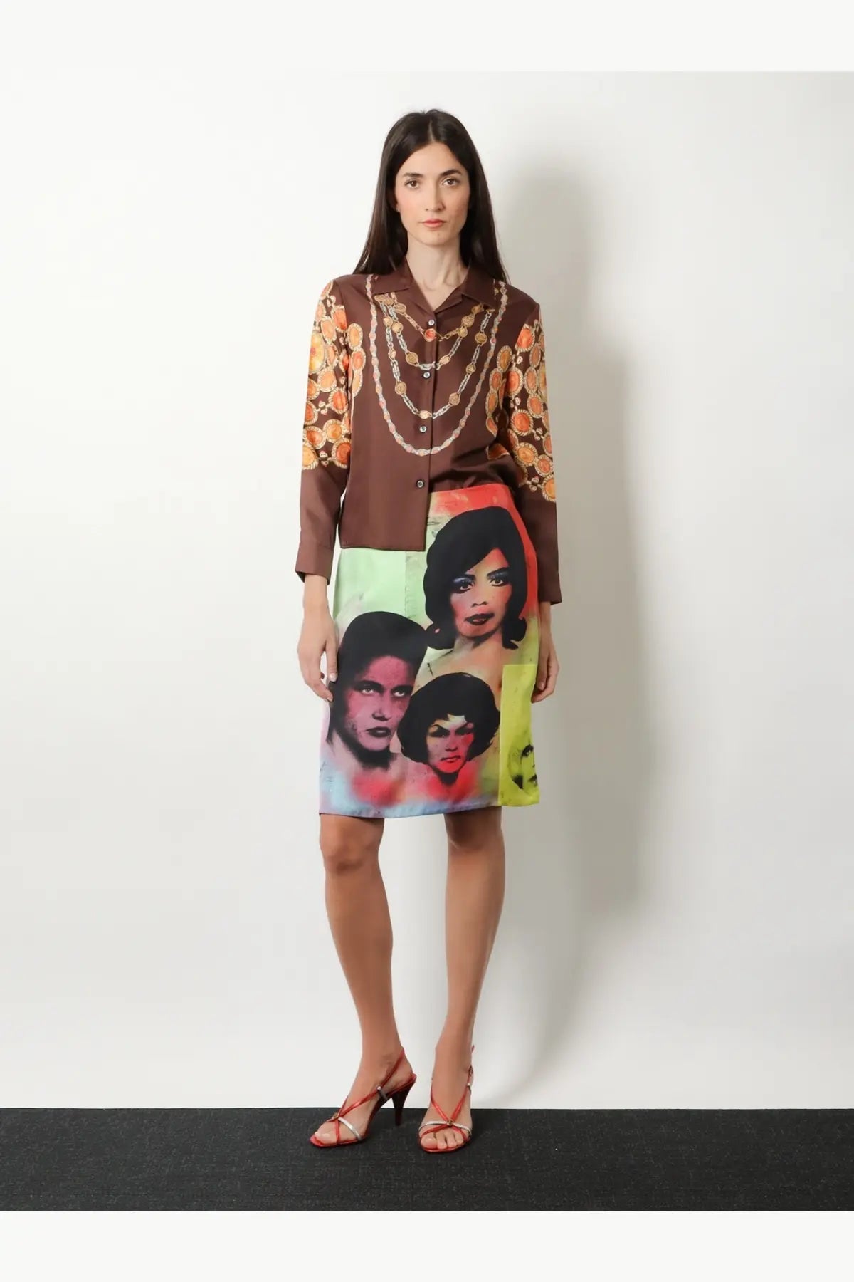 Versace women’s informal brown silk blouse with vibrant orange gold floral sleeves paired with colorful pop-art skirt