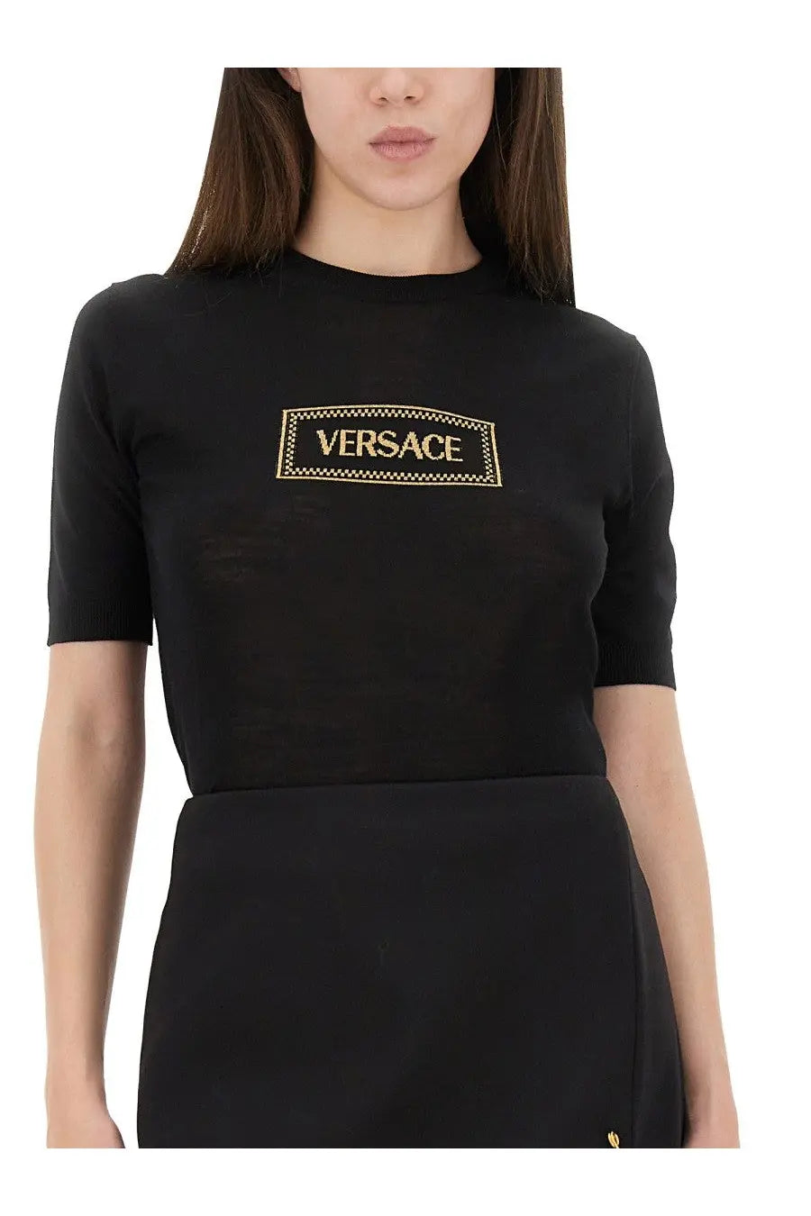 Versace women’s black short-sleeved knit shirt with gold embroidered logo in a rectangular frame