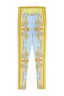 Versace women’s light blue and gold ornate patterned leggings with bold baroque-inspired design
