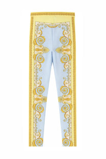 Versace women’s light blue high-waisted leggings with ornate gold baroque pattern and bold yellow trim on sides