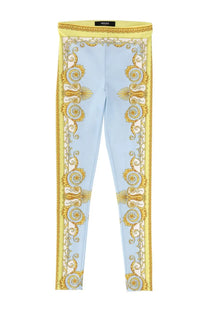 Versace women’s light blue leggings with ornate gold baroque pattern on sides and waistband for stylish wear