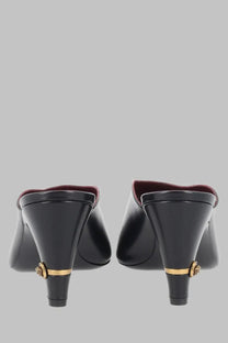Back view of versace women’s black leather mule giulietta with gold-tone medusa head embellishments on heels