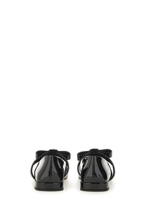 Black patent leather Versace women’s ballerina flats with glossy finish and decorative bow on the back view