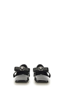 Versace women’s patent leather mary jane flats in black with glossy finish and silver medusa head emblem on strap