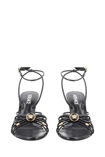 Versace women’s black leather sandalo opera bow sandals with gold-tone medusa head and crisscross straps