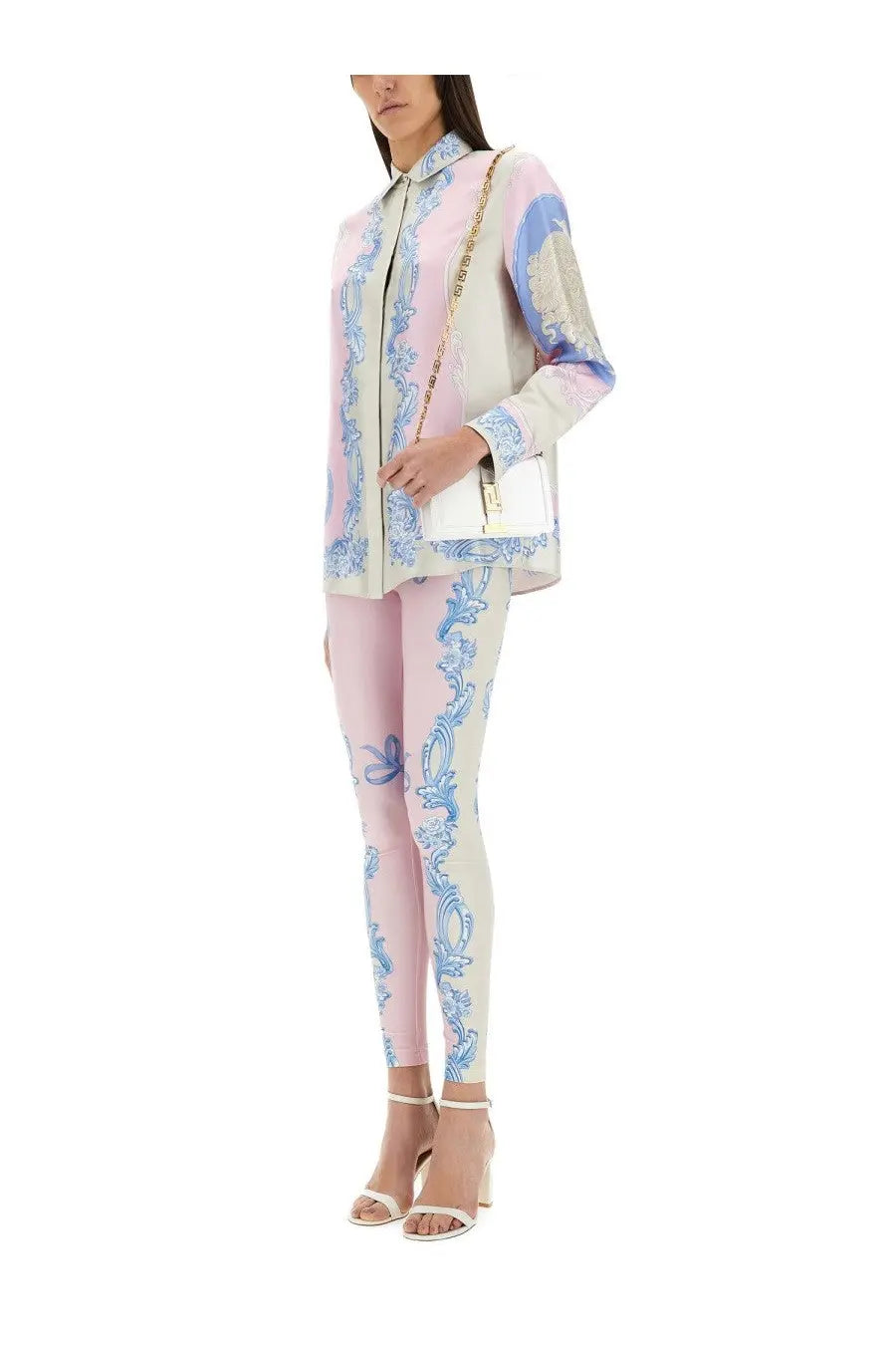 White chain-strap handbag with gold-tone clasp and minimalist design paired with versace women’s silk shirt cameo blue
