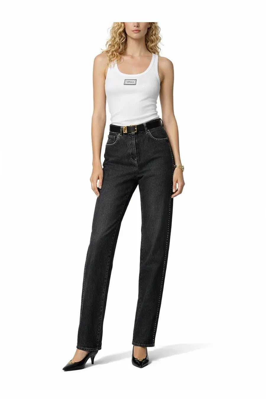 High-waisted black denim jeans with straight-leg cut and gold stitching along the sides paired with versace women’s white tank top