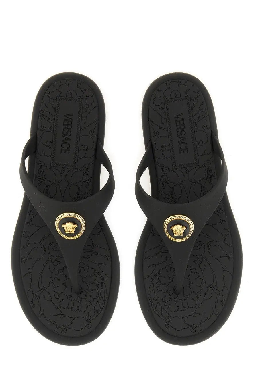 Versace women’s black rubber thong sandal with gold medusa head emblem and embossed floral sole pattern