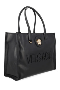 Versace women’s black leather tote bag with embossed logo and gold-tone medusa emblem for stylish carrying