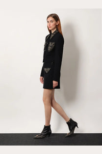 Black blazer with intricate silver embellishments on collar and pockets paired with versace women’s virgin wool mini skirt black