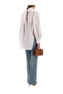 A tan leather mini handbag with a structured rectangular shape and gold-tone clasp by victoria beckham