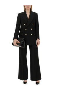 Black leather clutch with gold chain strap complementing victoria beckham women’s double breasted jacket black