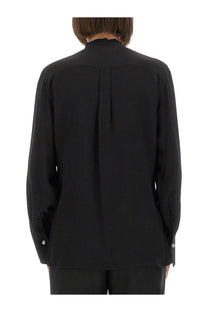 Black silk long-sleeved blouse by Victoria Beckham with high collar and subtle pleats on the back shown from rear view