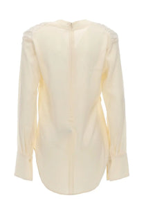 Cream-colored silk long-sleeved blouse with ruched shoulders and central back zipper by Victoria Beckham visible from back side