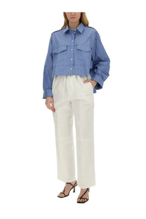 Blue and white vertically striped button-up shirt with two chest pockets paired with victoria beckham white wide leg pants