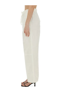 Cream-colored victoria beckham women’s wide-leg trousers with drawstring waist and subtle side pockets