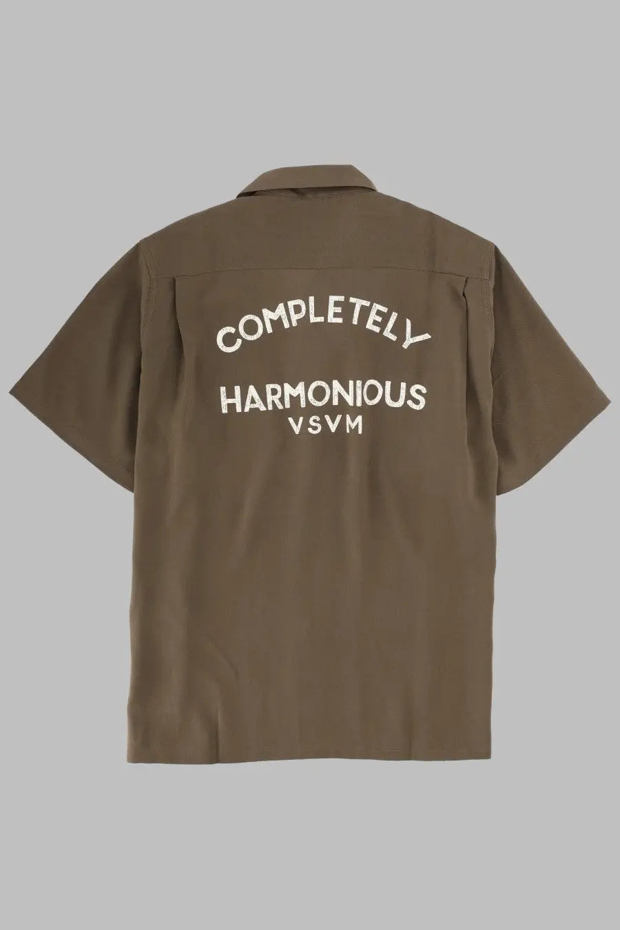 Visvim men’s brown short-sleeved button-up shirt showing white embroidered text on the back