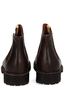 Dark brown visvim men’s leather chelsea boots with chunky black rubber sole and visible stitching