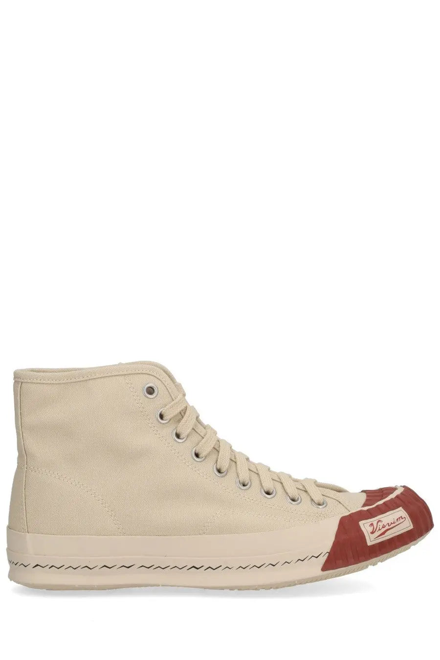 Beige canvas visvim men’s skagway hi sneaker with red toe cap and zigzag stitching along the sole